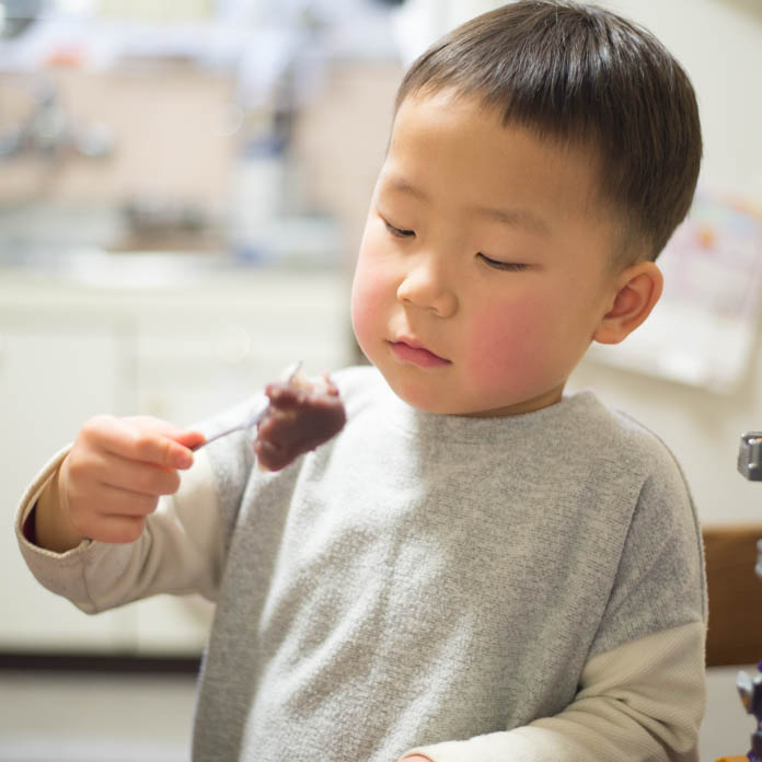 初めての赤福餅を眺める4歳の男の子