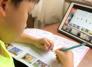 iPadでリモート学習を受けている小学1年生