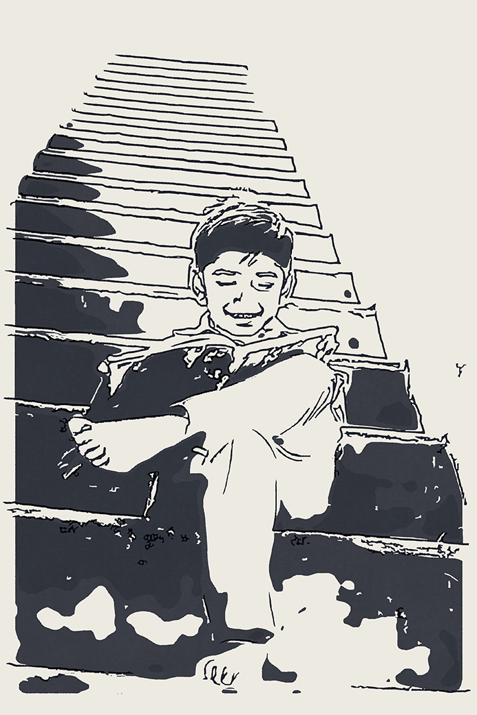 階段で読書している男の子